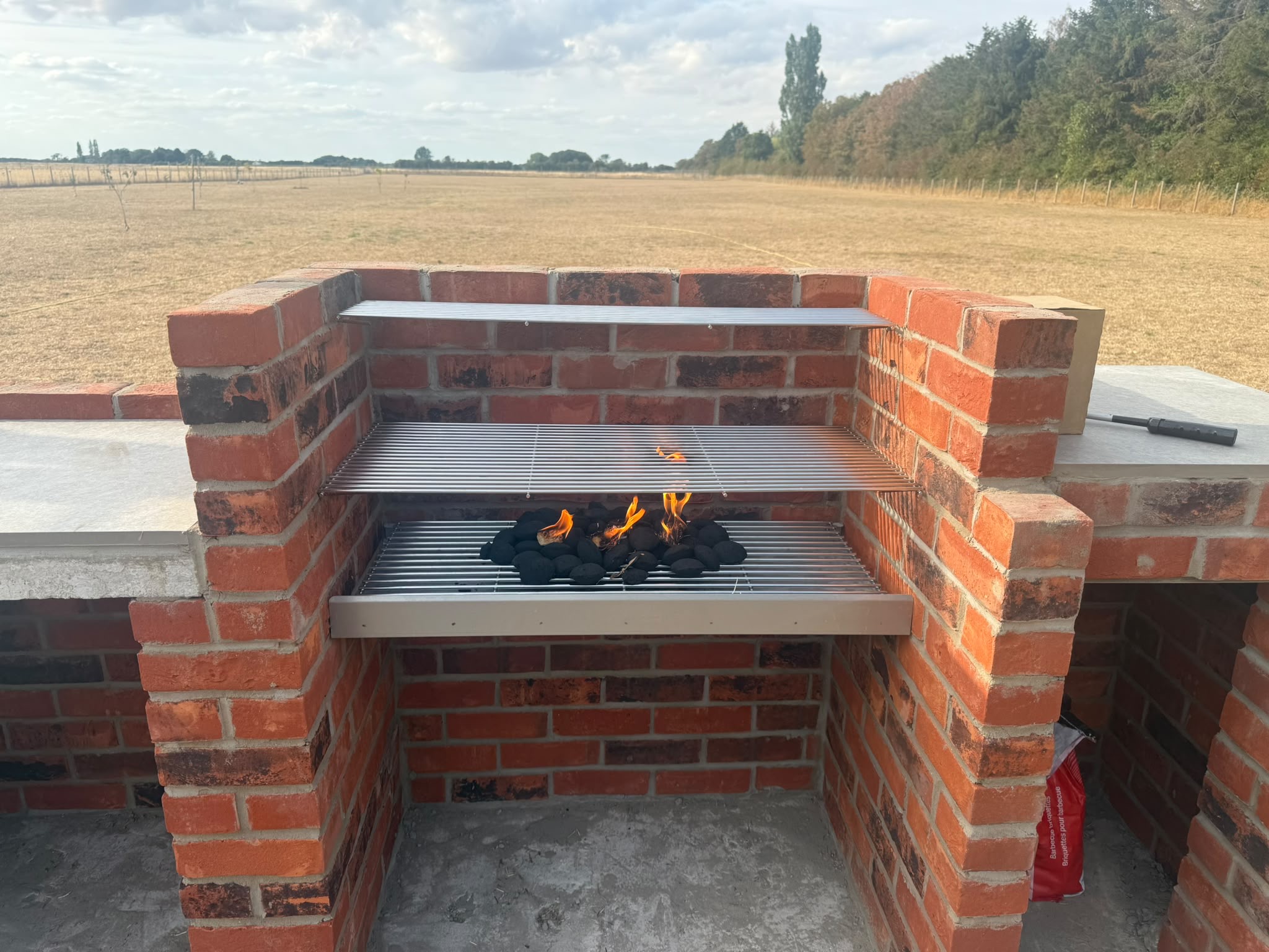 Brick outdoor grill with coals lit