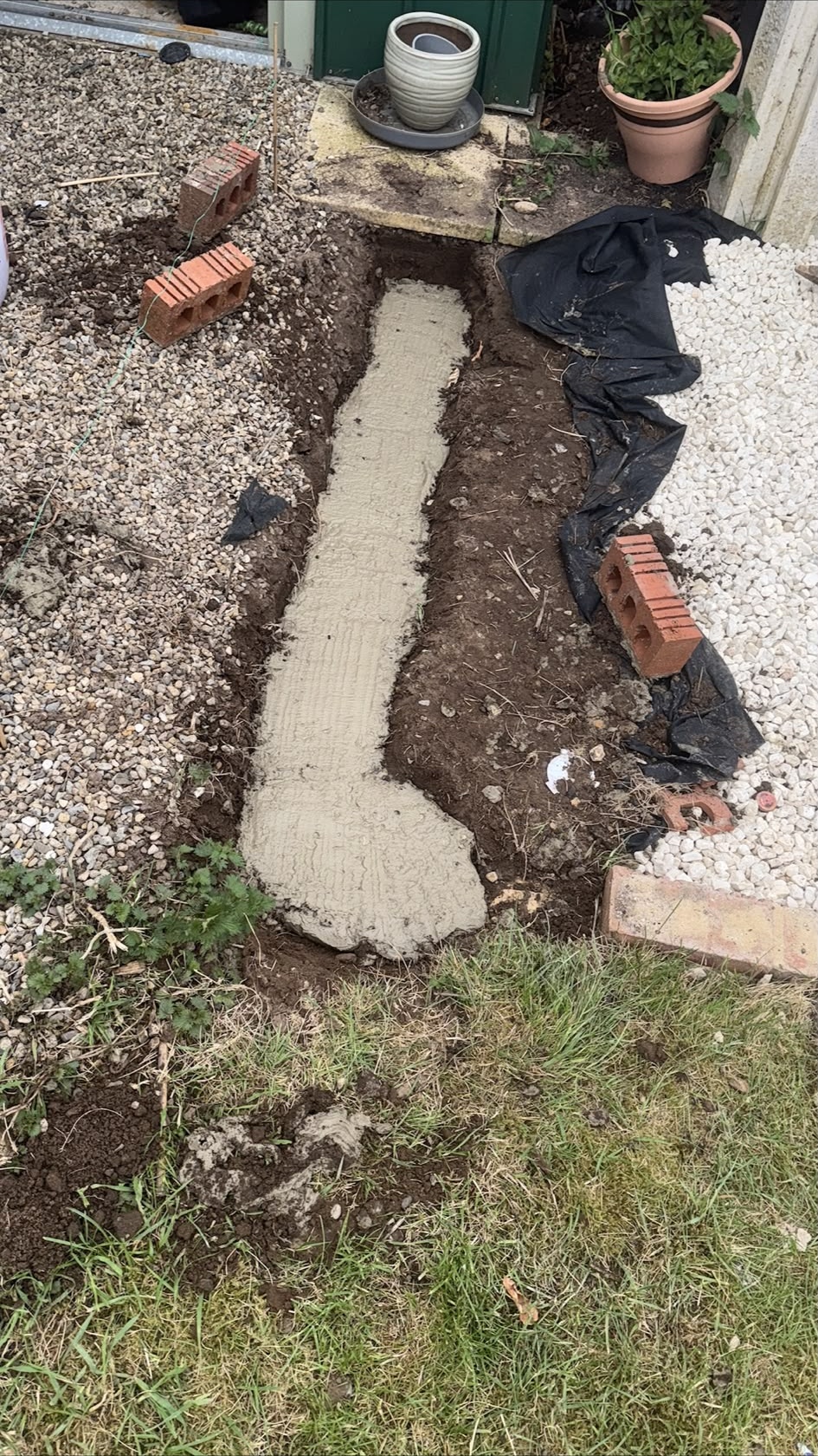 Fresh concrete footing prepared for new brickwork