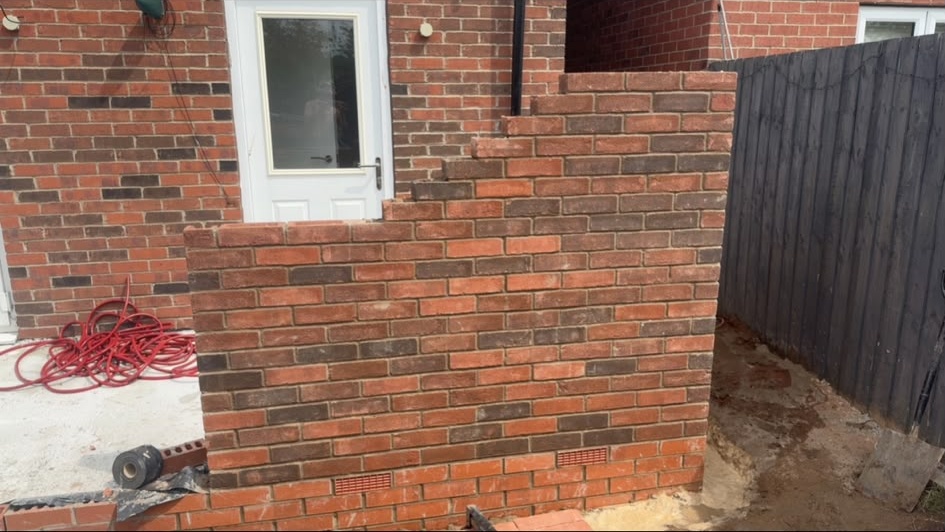Stepped brick wall in a rear garden